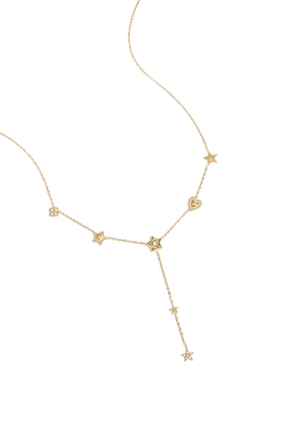 Delicate gold-tone necklace featuring multiple star and heart pendants with rhinestone accents laid on white background