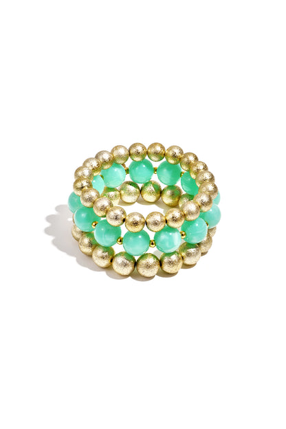 Trio of stretch bracelets featuring alternating mint green translucent beads and textured gold metallic beads.
