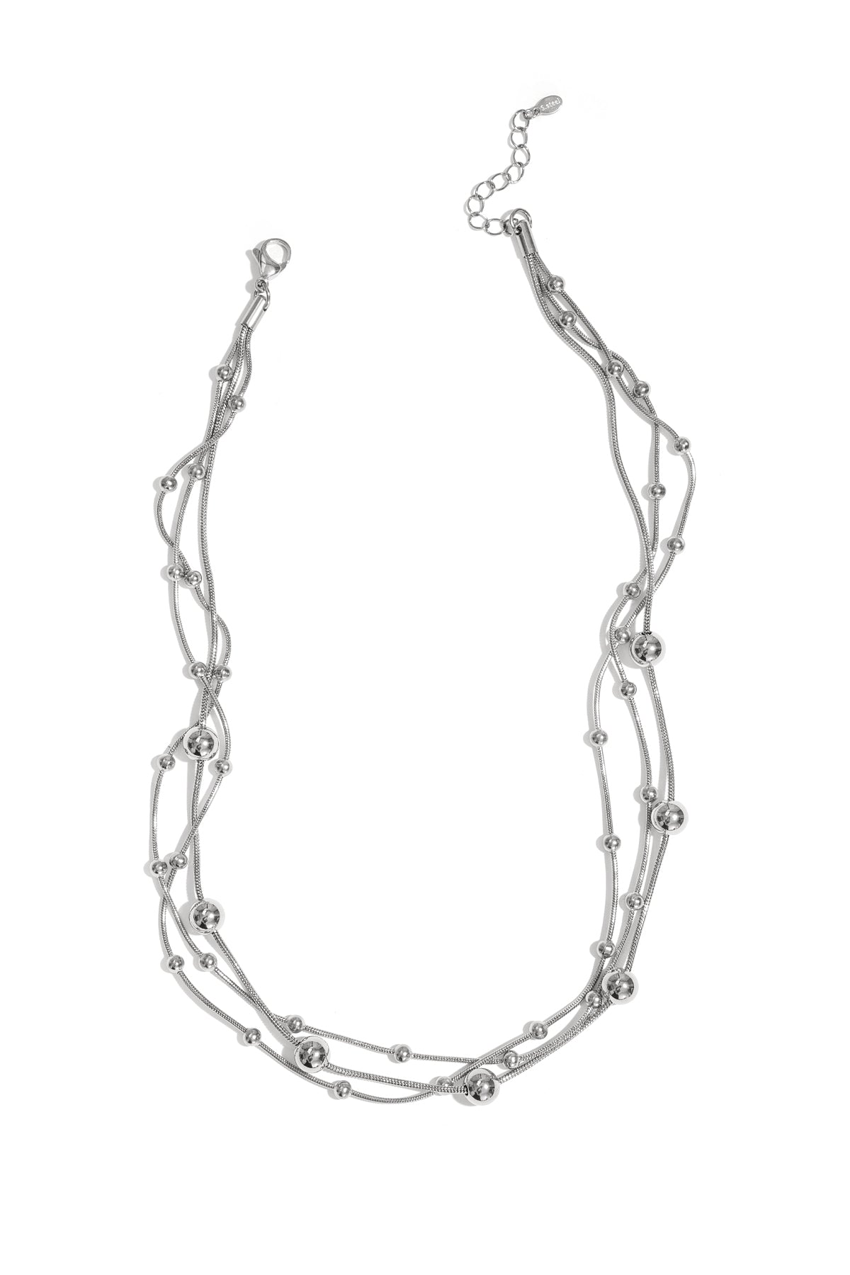 Silver multi-layered necklace with small and large beads laid flat on white background