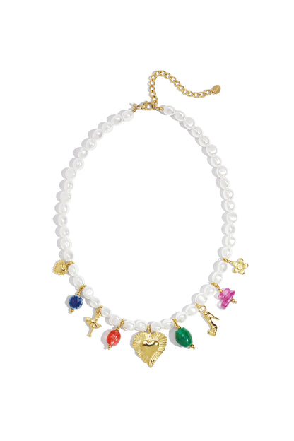 Flat lay of a white imitation pearl necklace adorned with colorful gold charms, including a heart, ballerina, high heel, and flowers, against a white background