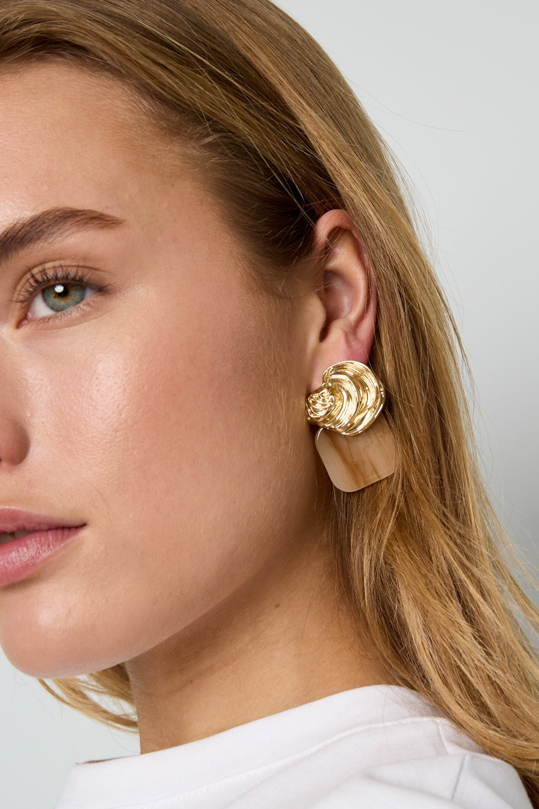 Gilded Glitch Hoops: gold-tone earrings with a textured, circular top and a smooth, tan translucent square drop.