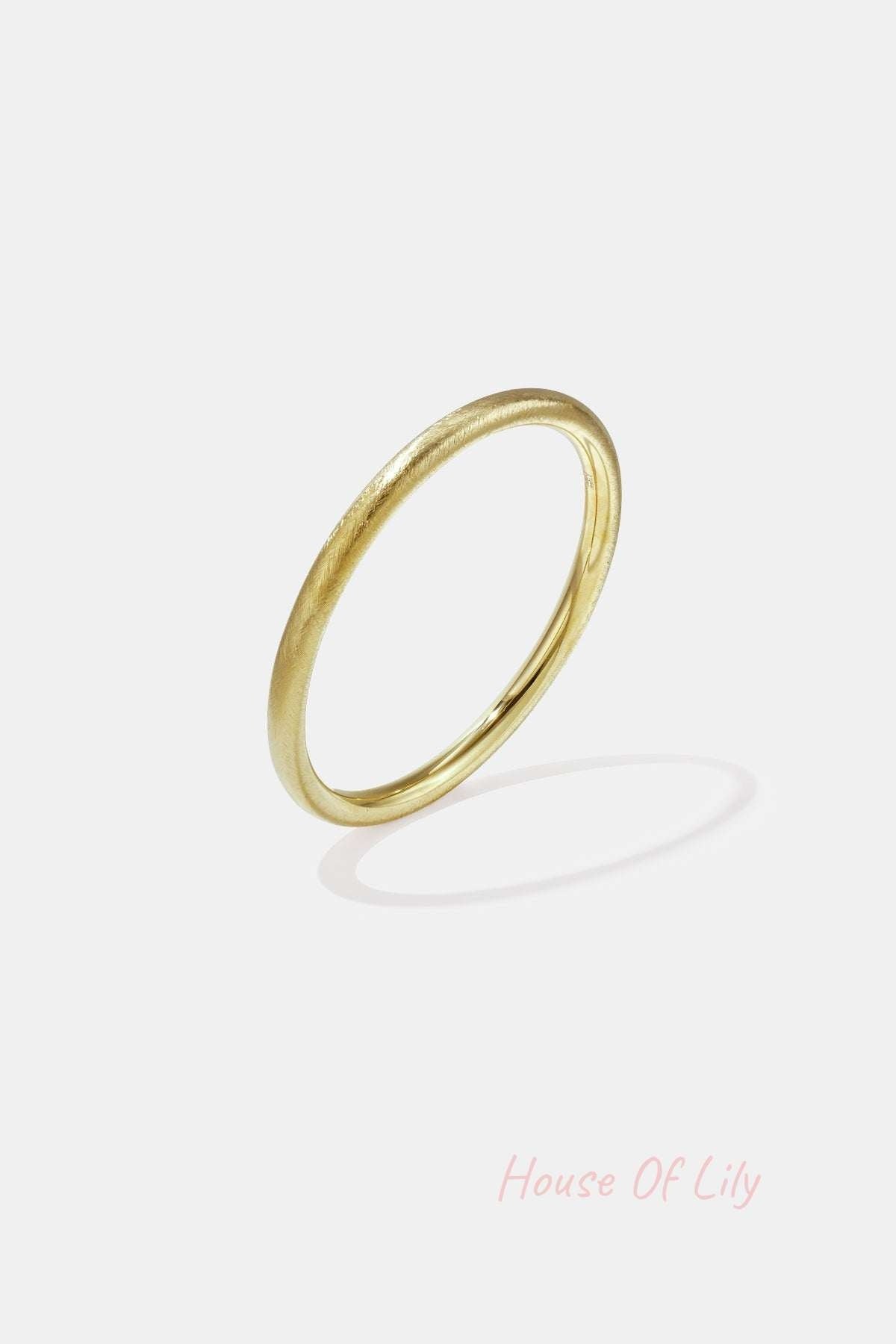 Minimalist gold brushed metal circle bangle isolated on white background
