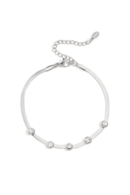 Silver-tone chain bracelet featuring five clear rhinestones with adjustable lobster clasp on white background