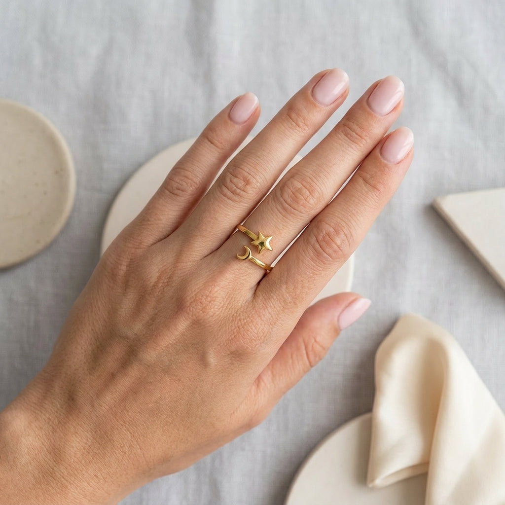 Gold Celestial Mood Ring featuring an open band design with a delicate star and crescent moon on a woman's finger.