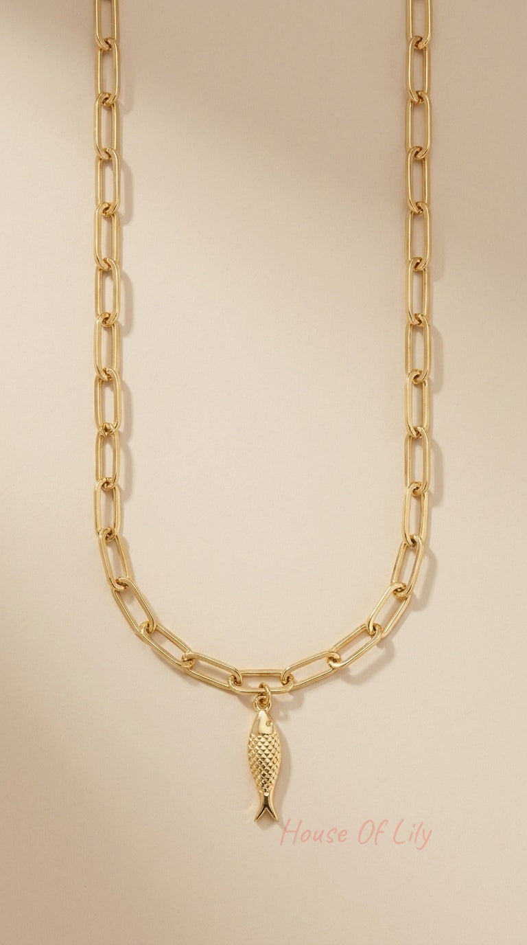 Gold-tone paperclip chain necklace featuring a textured, scale-detail fish charm pendant.