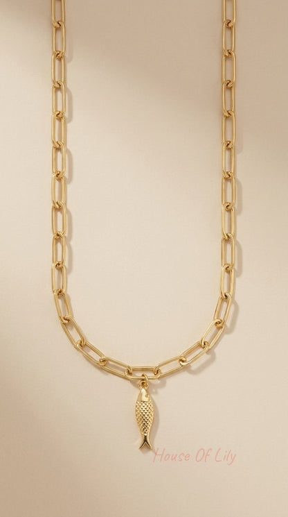 Gold-tone paperclip chain necklace featuring a textured, scale-detail fish charm pendant.