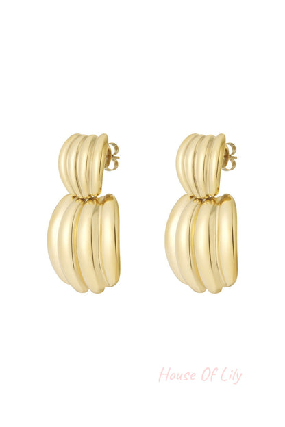 Pair of polished gold chunky hoop earrings with ribbed texture on white background