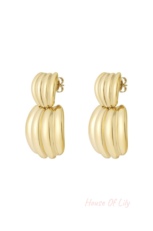 Pair of polished gold chunky hoop earrings with ribbed texture on white background