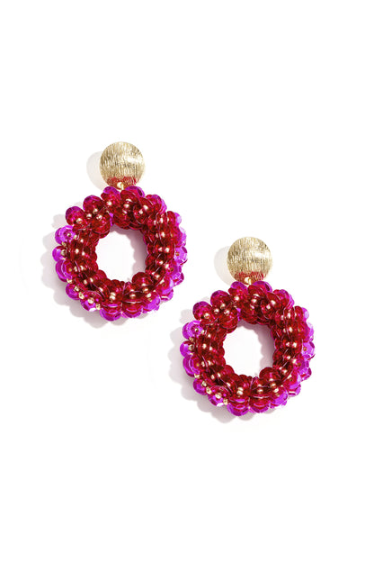 Drip In Disco earrings feature vibrant pink sequin-covered hoops hanging from textured gold disc studs.