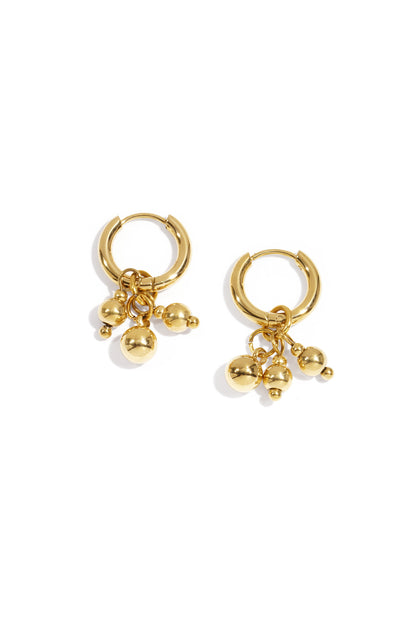 Gold hoop earrings with three small dangling spheres on a white background