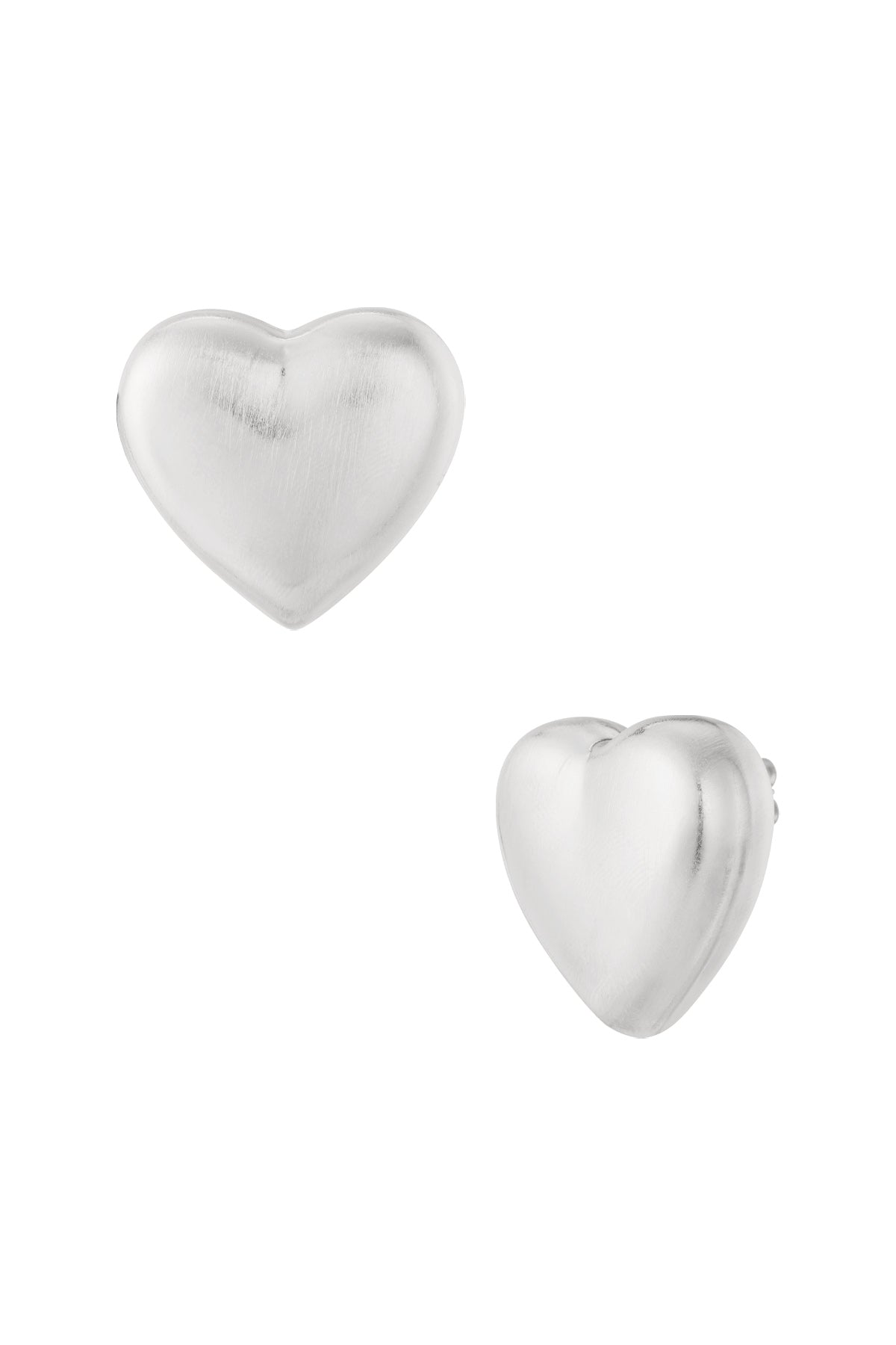 Close-up of matte silver heart-shaped stud earrings on white background
