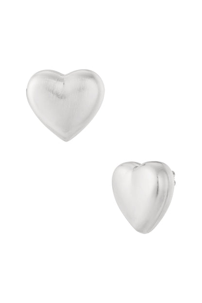 Close-up of matte silver heart-shaped stud earrings on white background