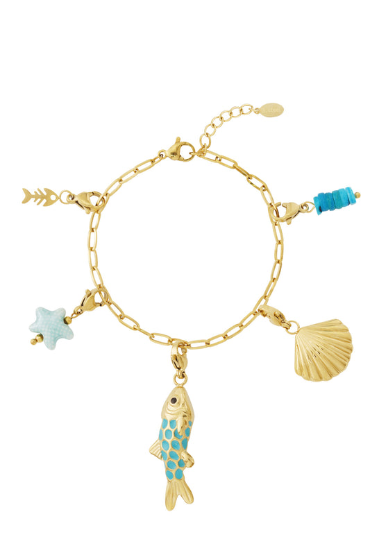 Top view of a gold charm bracelet displayed flat with five removable charms: turquoise enamel fish, gold scallop shell, fish skeleton, light blue starfish, and stacked turquoise beads