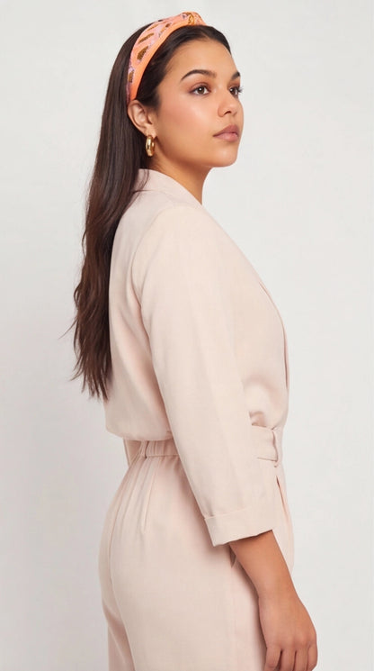 Model wearing polished, thick gold hoop earrings, showcasing a minimalist and classic circular design.
