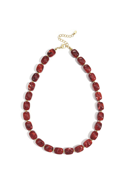 Single deep red rectangular acrylic beaded necklace with gold-tone lobster clasp and extender chain laid flat