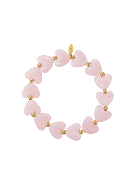Soft pink marbled heart beaded stretch bracelet with gold accent beads on white background