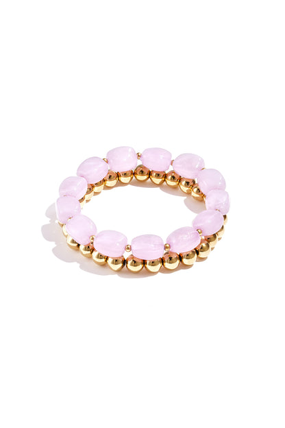 Light pink marbled acrylic beaded bracelet paired with shiny gold-tone beaded bracelet on white background