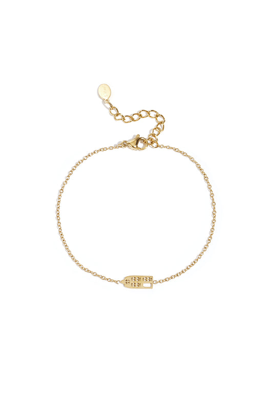 Gold domino charm bracelet with delicate fine chain and adjustable clasp on white background