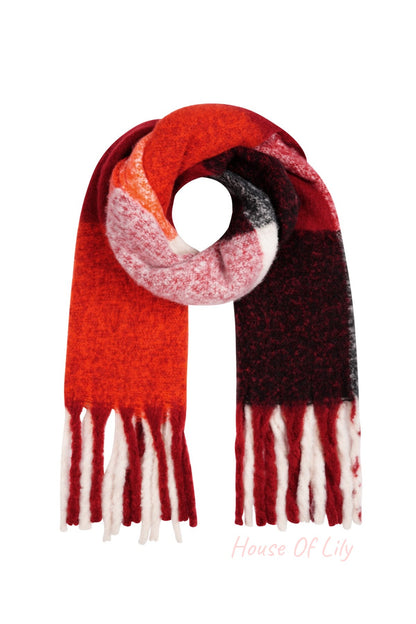 Folded scarf with bold color blocks in red, orange, white and black with long fringes