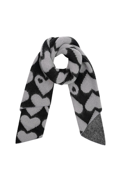 Black and gray chunky knit scarf with bold heart design shown looped