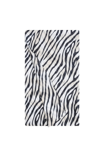 Close-up of folded zebra print scarf highlighting soft fabric texture and elegant animal stripe design