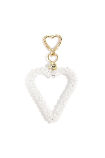 White beaded open heart keychain attached with gold hardware on white background