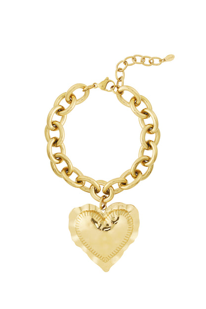 Gold chunky link bracelet with large hammered heart charm pendant on white background