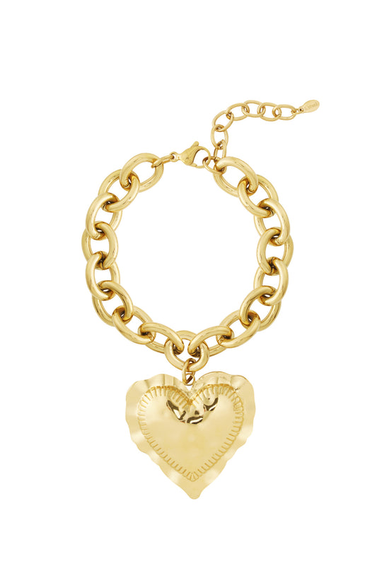 Gold chunky link bracelet with large hammered heart charm pendant on white background