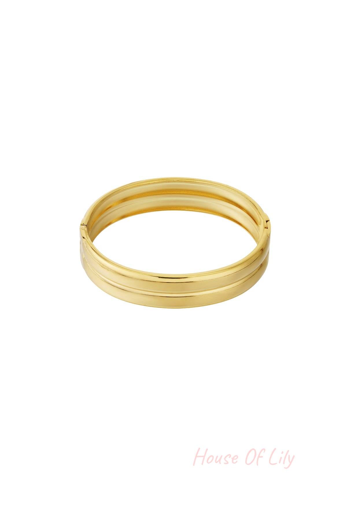 Close-up image of a shiny gold minimalist double-band bangle with smooth polished finish on white background