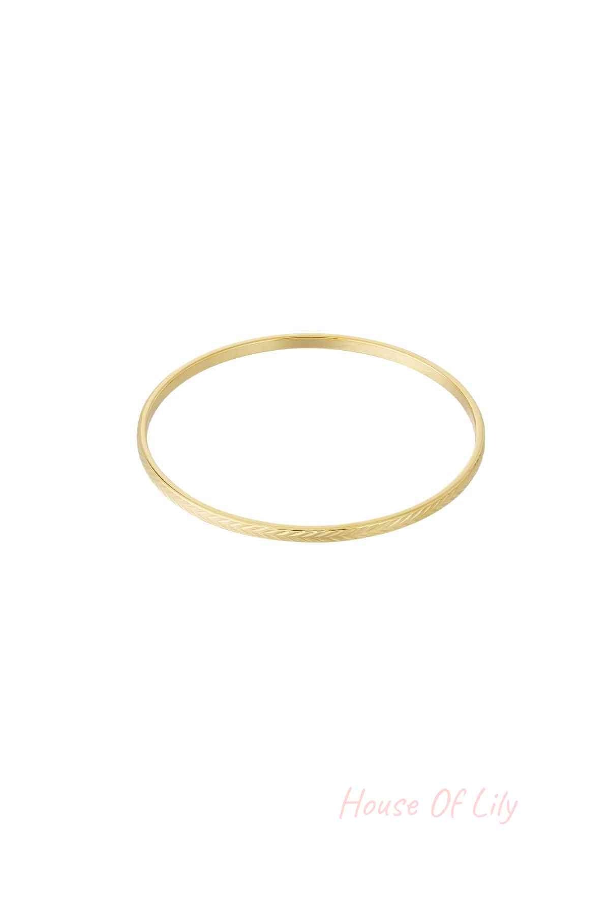 Gold textured bangle with fine etched pattern on white background