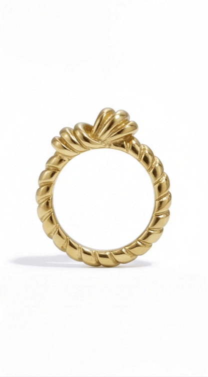 A gold ribbon knot ring featuring a twisted rope-style band, isolated on a white background.