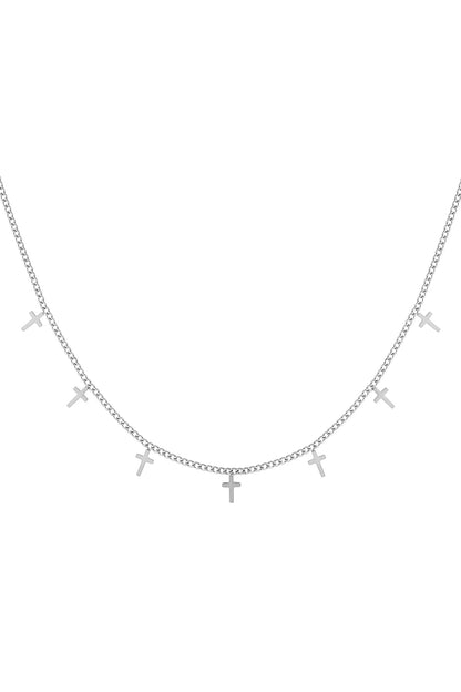 Silver chain necklace with seven small cross charms evenly spaced on white background