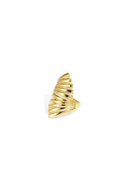 Close-up of a gold sculptural statement ring with a wave design on a white background