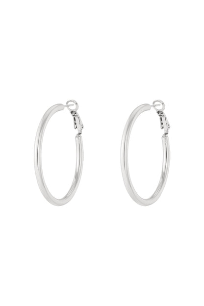 Pair of sleek silver hoop earrings on white background