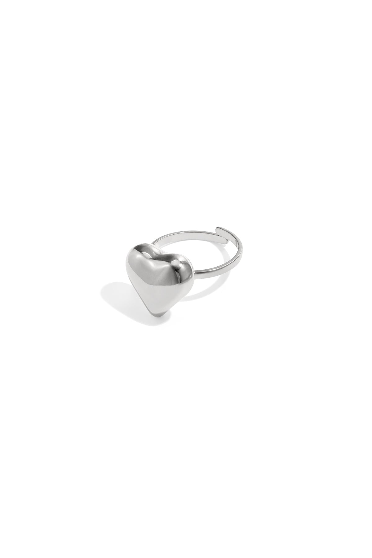 Silver puffy heart adjustable ring on white background