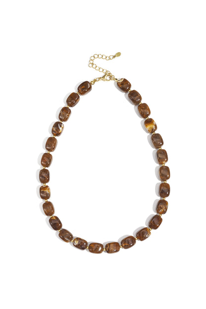 Flat lay of chunky green marbled rectangular acrylic beaded necklace with gold-tone clasp and extender