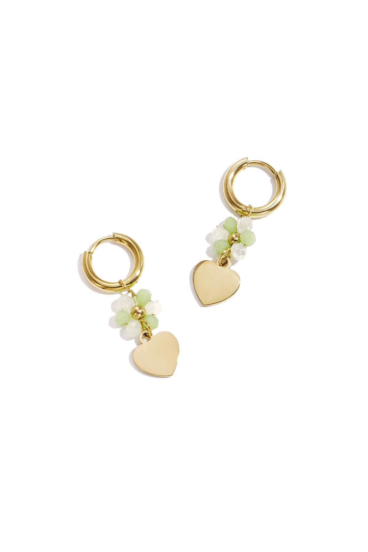 Pair of gold-tone hoop earrings with white and light green faceted beads and dangling gold heart charms on white background