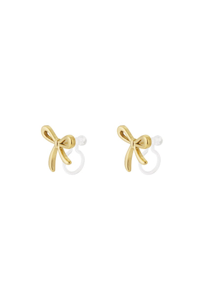 Pair of gold bow-shaped clip-on earrings with smooth polished finish on white background