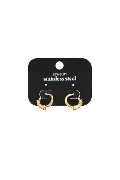 Gold-tone stainless steel hoop earrings featuring a partial row of baguette-cut crystals on a black display card.