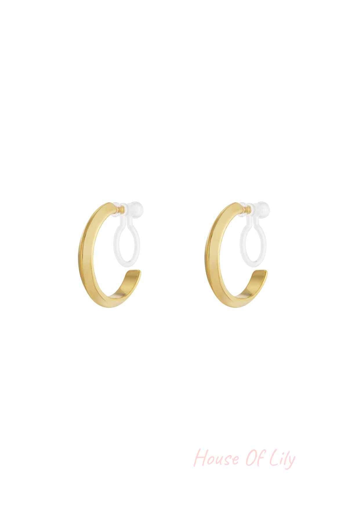 Pair of minimalist 14K gold plated clip-on hoop earrings with smooth rounded design on white background