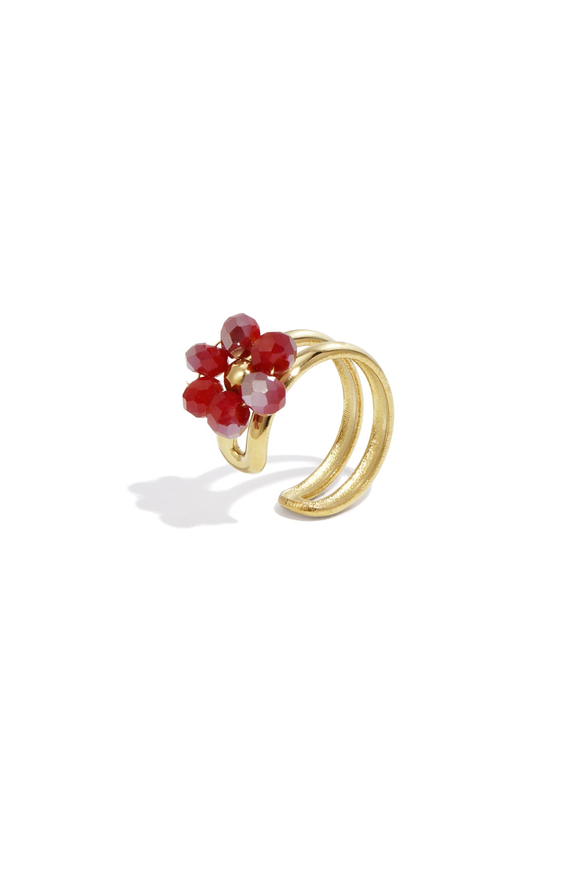 Gold-tone floral ear cuff featuring red faceted beads on a white background