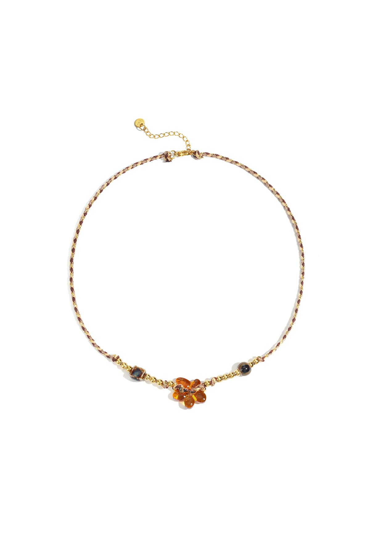 Flower beaded necklace with a braided cord in warm brown and gold-tone beads laid flat on a white background