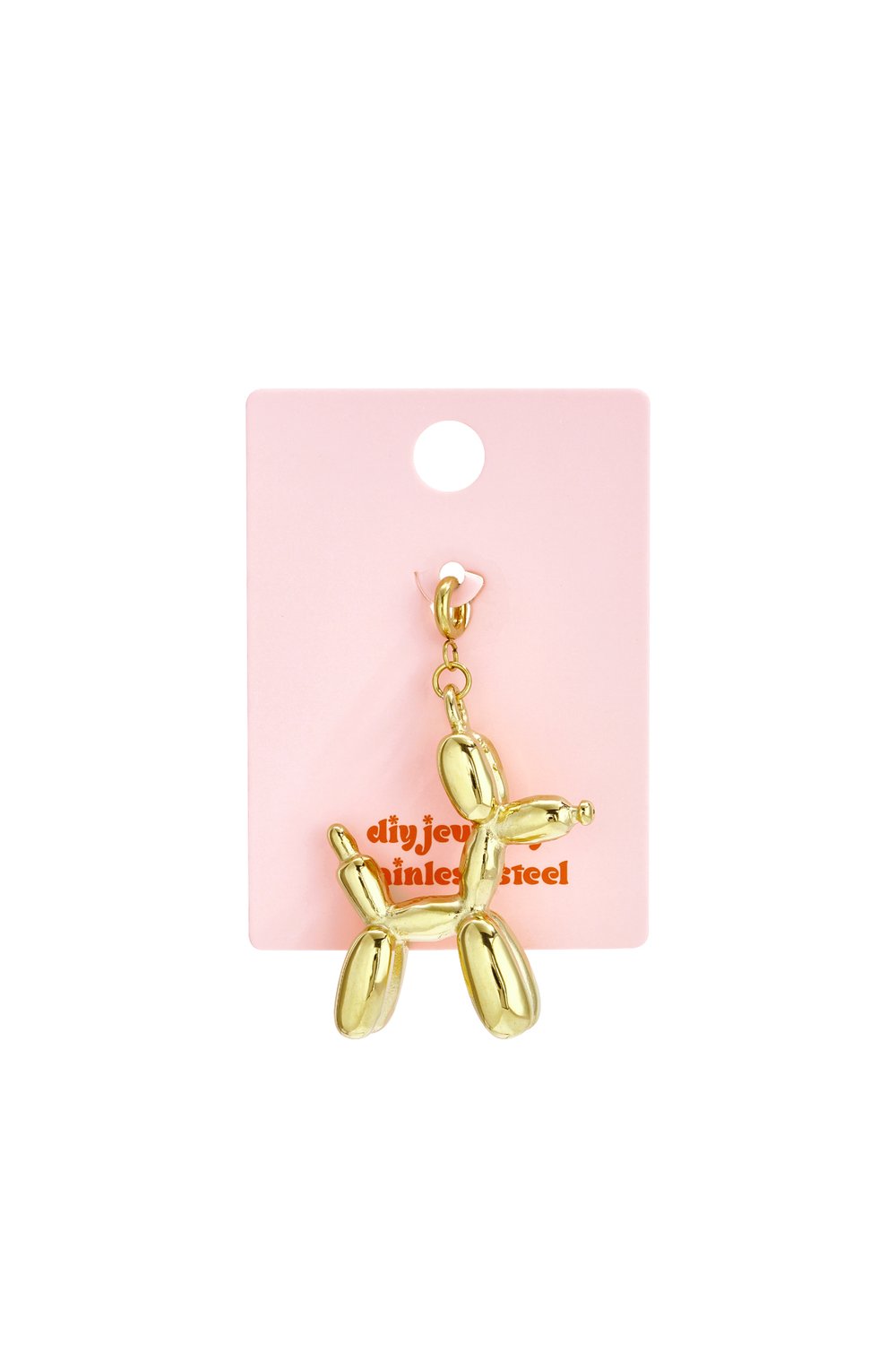 Gold-tone stainless steel balloon dog charm on a pink display card. High-shine, playful sculptural jewelry piece.