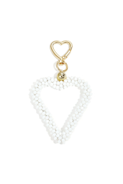 White beaded heart keychain with gold clasp on white background