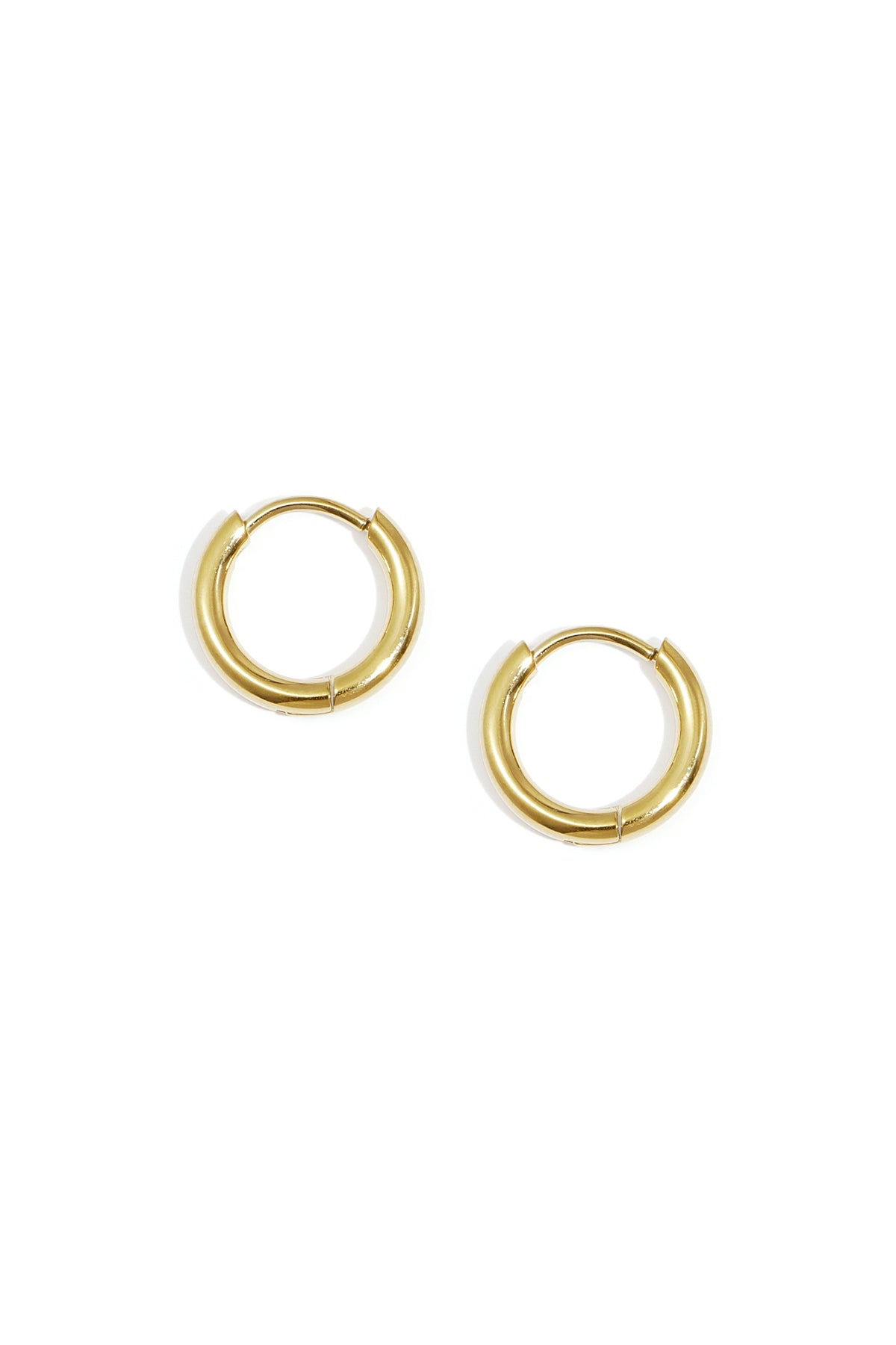 Pair of minimal classic gold hoop earrings on white background