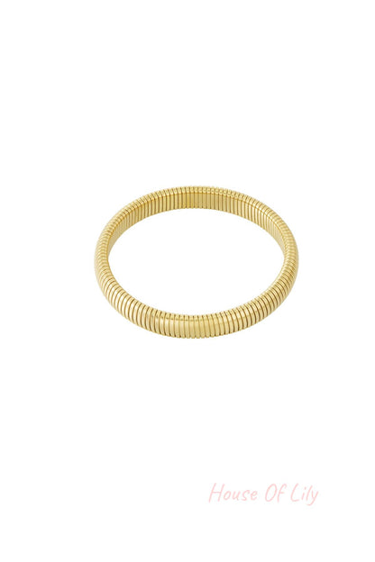 Another angle of the gold stretch bracelet showing its flexible segmented design on white background