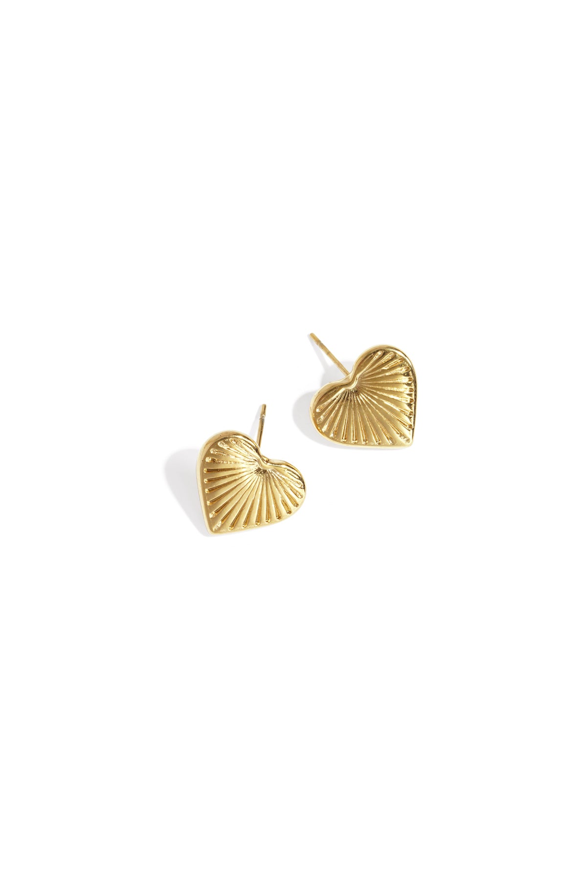Gold-tone heart-shaped stud earrings with textured sunburst pattern on white background