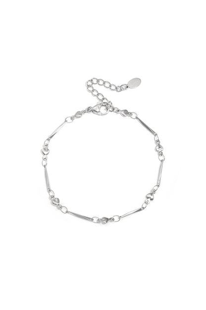 Close-up image of a delicate silver heart link bracelet with lobster clasp and adjustable chain on white background.