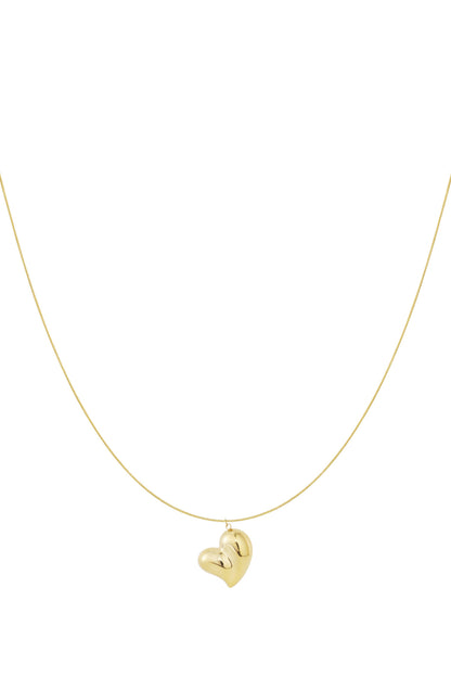 Delicate gold heart pendant necklace with a smooth thin chain against a white background