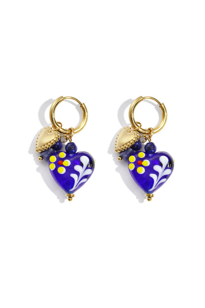 Pair of gold hoop earrings with royal blue glass heart charms decorated with yellow and red flowers and gold heart pendants